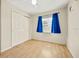 Bedroom featuring wood floors, blue curtains and double door closet at 6432 Delta Leah Dr, Orlando, FL 32818