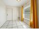 Small dining area with tile floor and yellow curtains at 6432 Delta Leah Dr, Orlando, FL 32818