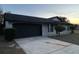 Newly painted home with a black garage door and landscaping at 6432 Delta Leah Dr, Orlando, FL 32818