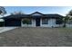 Newly painted home with black accents and landscaping at 6432 Delta Leah Dr, Orlando, FL 32818
