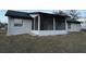 Exterior view of a house with a screened porch at 6432 Delta Leah Dr, Orlando, FL 32818