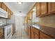 Bright kitchen with wood cabinets, granite countertops, and white appliances at 6432 Delta Leah Dr, Orlando, FL 32818