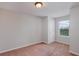 A simple, carpeted bedroom with a window providing natural light at 8375 Lovett Ave, Orlando, FL 32832