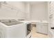 Efficient laundry room equipped with modern washer, dryer, and sink at 8631 Dubochet St, Orlando, FL 32827