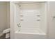Bathroom featuring a tub and shower combination with tile surround and built in shelving at 878 Rockhill St, Deltona, FL 32725