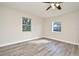Bright bedroom featuring hardwood floors, two windows and a modern ceiling fan at 878 Rockhill St, Deltona, FL 32725