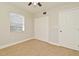 This bedroom features neutral carpet, a double-door closet and a window for natural light at 878 Rockhill St, Deltona, FL 32725