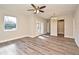 Open-concept living room with wood-look floors, neutral walls, and access to other rooms at 878 Rockhill St, Deltona, FL 32725