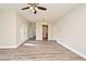 Open-concept living room featuring wood-look floors, neutral walls, and access to other rooms at 878 Rockhill St, Deltona, FL 32725
