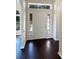 Inviting entryway with dark hardwood floors and a white door at 8920 Fort Jefferson Blvd, Orlando, FL 32822