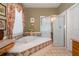 Bright bathroom featuring a soaking tub and separate glass shower at 402 Turnstone Way, Orlando, FL 32828