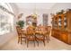 Formal dining room with a wooden table set, china cabinet, decorative wall art, and natural light at 402 Turnstone Way, Orlando, FL 32828