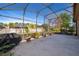 Screened lanai with a high ceiling, potted plants and view of the backyard at 402 Turnstone Way, Orlando, FL 32828