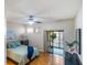 Bright bedroom with wood floors, fan, and a sliding door to outdoor area at 1000 Winderley Pl # 122, Maitland, FL 32751