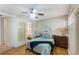 Cozy bedroom with wood floors, neutral walls, and blue bedding accents at 1000 Winderley Pl # 122, Maitland, FL 32751