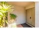 Condo building entryway with double doors and potted plants at 1000 Winderley Pl # 122, Maitland, FL 32751