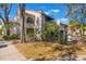 Charming two-story condo featuring stucco walls, red tile roof, and well-maintained landscaping at 1000 Winderley Pl # 122, Maitland, FL 32751