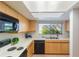 Galley kitchen featuring light wood cabinetry and a window view at 1000 Winderley Pl # 122, Maitland, FL 32751