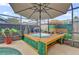 Enjoyable hot tub with wooden enclosure and umbrella at 104 Sunny Oak Trl, Kissimmee, FL 34746