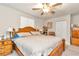 Main bedroom with a king-size bed, nightstands, and a ceiling fan at 10897 Sw 80Th Ct, Ocala, FL 34481