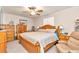 Main bedroom with a king-size bed, wooden dresser, and ceiling fan at 10897 Sw 80Th Ct, Ocala, FL 34481