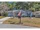 Ranch-style home with gray siding, front porch, and landscaped yard at 10897 Sw 80Th Ct, Ocala, FL 34481