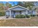 Gray house with a front porch and well-manicured lawn at 10897 Sw 80Th Ct, Ocala, FL 34481