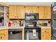 Kitchen with black appliances and wood cabinets at 10897 Sw 80Th Ct, Ocala, FL 34481