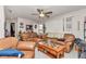 Spacious living room featuring brown leather sofas and a coffee table at 10897 Sw 80Th Ct, Ocala, FL 34481