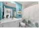 Well-lit bathroom features a large mirror, ample vanity space, and refreshing turquoise accents at 11753 Fan Tail Ln, Orlando, FL 32827