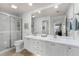 Bright bathroom offering dual sinks, a glass enclosed shower, and neutral tones for a spa-like feel at 11753 Fan Tail Ln, Orlando, FL 32827