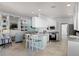 Bright kitchen with white cabinets, a breakfast bar, and stainless-steel appliances at 11753 Fan Tail Ln, Orlando, FL 32827