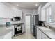 Efficient kitchen space featuring modern appliances, white cabinetry, and a functional layout at 11753 Fan Tail Ln, Orlando, FL 32827