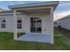 Covered back porch overlooking a well-maintained lawn, offering an inviting outdoor space at 1207 Tank Trl, Haines City, FL 33844