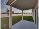 Spacious covered back porch, perfect for entertaining with a view of the fenced backyard at 1207 Tank Trl, Haines City, FL 33844