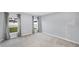 Bedroom with gray walls, carpet, and natural light from the windows with gray curtains at 1207 Tank Trl, Haines City, FL 33844