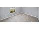 Carpeted bedroom with window bringing in natural light at 1207 Tank Trl, Haines City, FL 33844