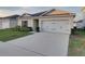 Well-maintained single-story home with an attached two-car garage and neat landscaping at 1207 Tank Trl, Haines City, FL 33844