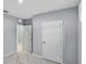 Hallway with carpet floors and white doors at 1207 Tank Trl, Haines City, FL 33844