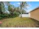 Large backyard featuring lush tropical landscaping, privacy fence, and mature trees provides tranquil setting at 13713 Meadowpark Ave, Orlando, FL 32826