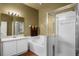 Bathroom featuring double sink vanity, a bathtub, and a glass-enclosed shower at 13713 Meadowpark Ave, Orlando, FL 32826