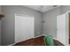 Bright bedroom featuring wood floors, a closet, an open door and gray walls at 13713 Meadowpark Ave, Orlando, FL 32826