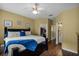 Bedroom featuring wood floors with ensuite bathroom and walk-in closet at 13713 Meadowpark Ave, Orlando, FL 32826