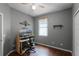 Cozy bedroom featuring computer desk, chair, window, ceiling fan, and gray walls at 13713 Meadowpark Ave, Orlando, FL 32826