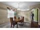 Traditional dining room with wooden table, chairs and chandelier lighting at 13713 Meadowpark Ave, Orlando, FL 32826