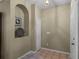 Welcoming foyer area with tile floors and arched design niche at 13713 Meadowpark Ave, Orlando, FL 32826