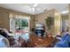 Living room with hardwood floors, sliding glass doors, and a view of the backyard patio at 13713 Meadowpark Ave, Orlando, FL 32826