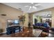 A living room features hardwood floors, entertainment center, and an archway to the kitchen at 13713 Meadowpark Ave, Orlando, FL 32826