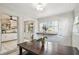 Cozy dining room adjacent to kitchen with natural light, wood table, and view into the kitchen space at 1412 Nebraska St, Orlando, FL 32803