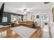 Bright living room featuring hardwood floors, a large sectional sofa, and ample natural light from the windows at 1412 Nebraska St, Orlando, FL 32803